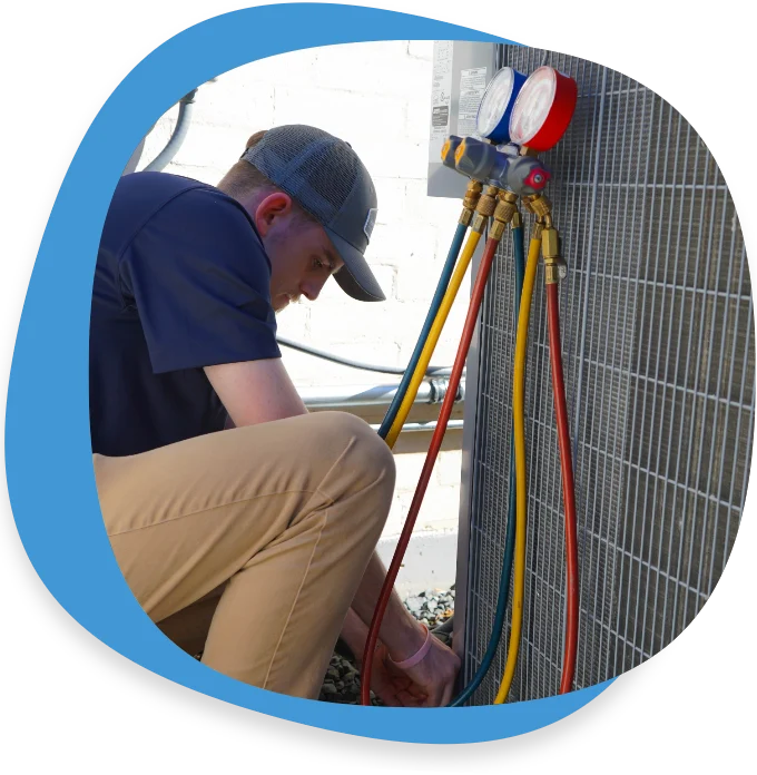 Technician checking AC refrigerant levels